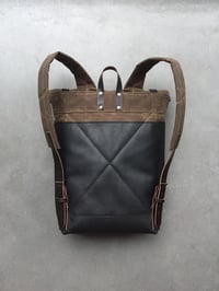 Image 3 of Black leather backpack with waxed canvas roll to close top and leather front pocket