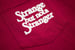Image of Strange but not, Pocket T, Crimson
