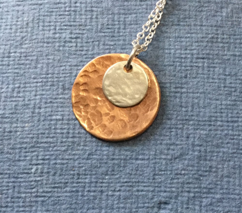 Image of Hammered copper disc pendant with a small sterling silver disc addition