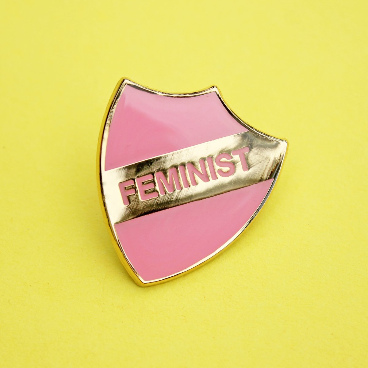 Image of FEMINIST - enamel pin, shield, pink with gold plating, merit style badge