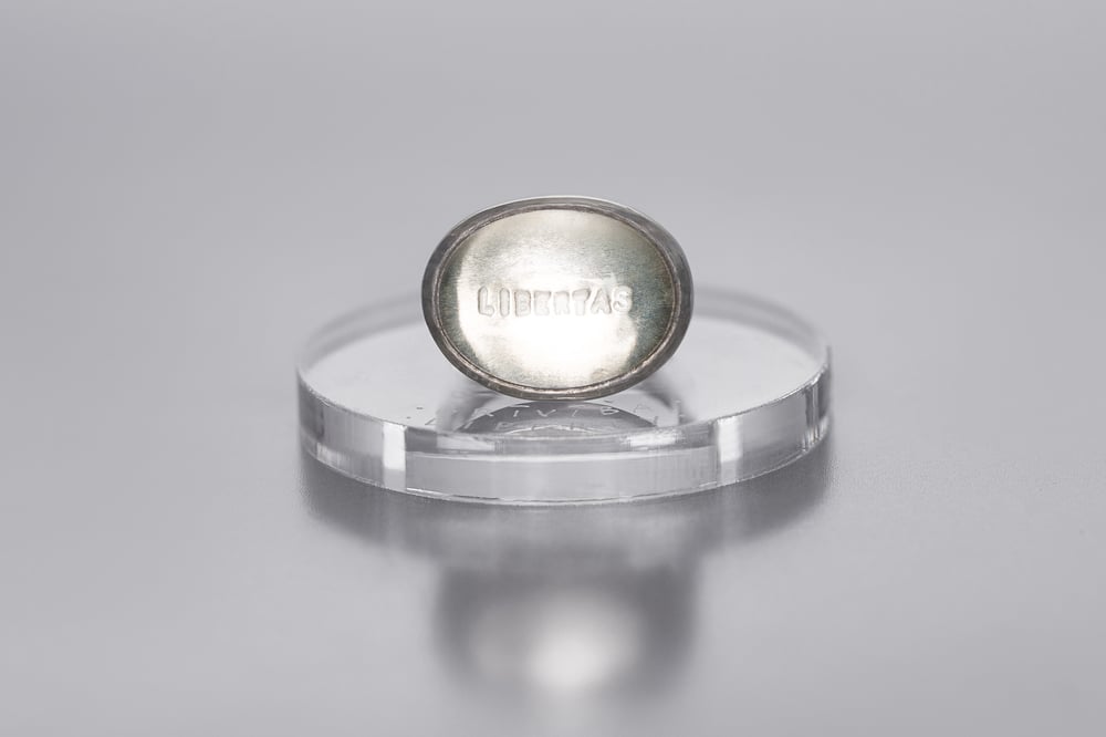 Image of silver ring with rock crystal and inscription in Latin