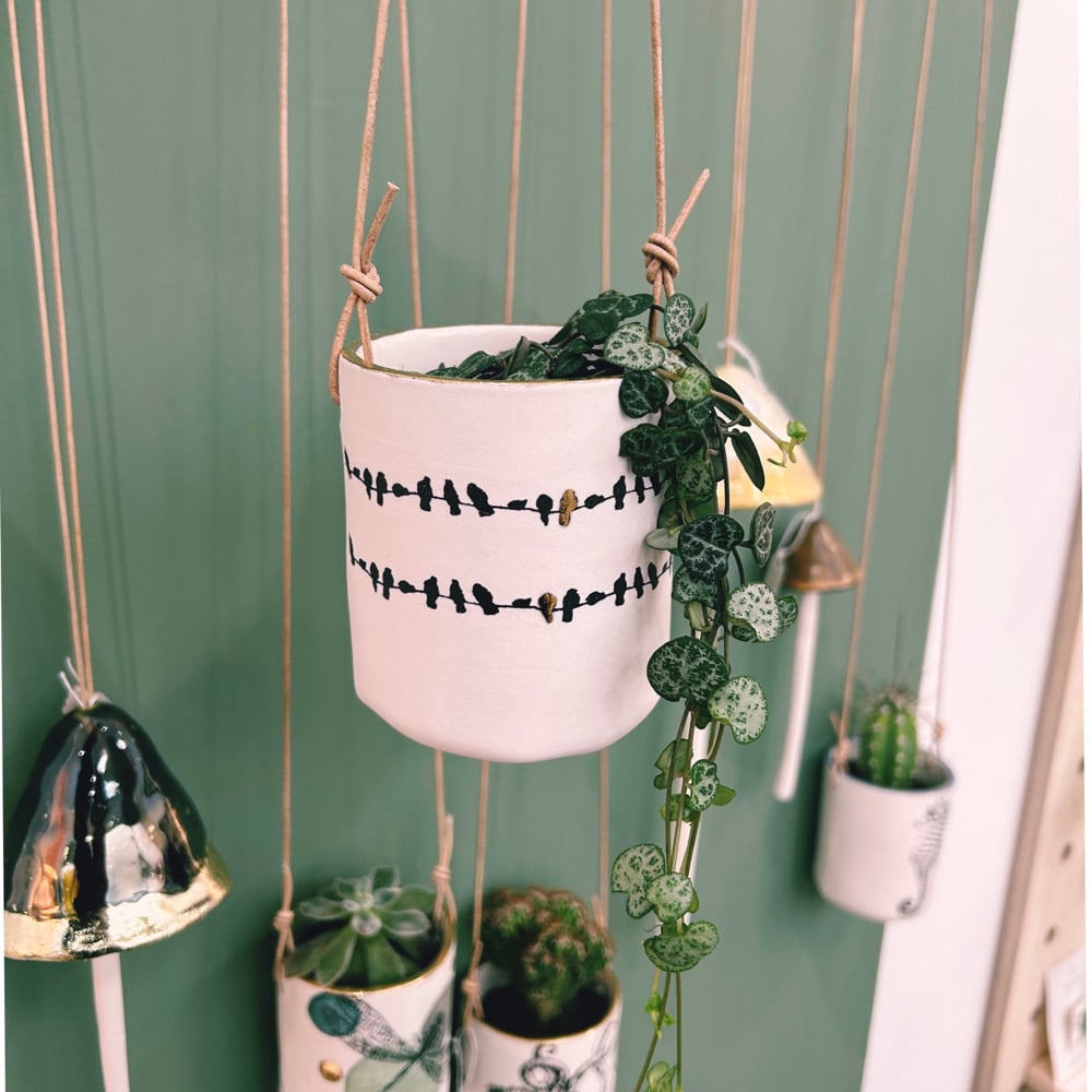 Porcelain hanging birds on a wire planter