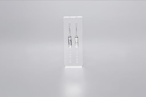 Image of light plain silver earrings with inscription in Latin