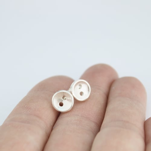 Image of small button stud earrings, smooth 2 hole buttons