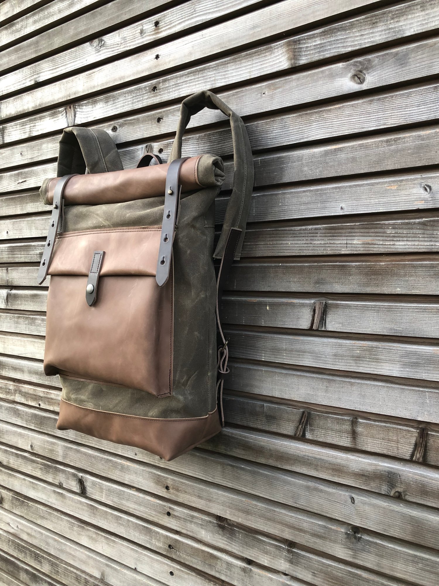Image of Waxed canvas backpack with roll up top and oiled leather bottem in dark taupe
