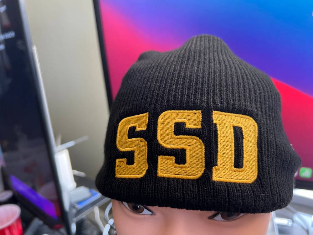 Black New Era Knit beanie hat with Solid Gold SSD logo 