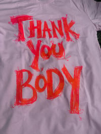 Image 1 of Thank You Body Shirt (MEDIUM) Pink with orange marbled  text.