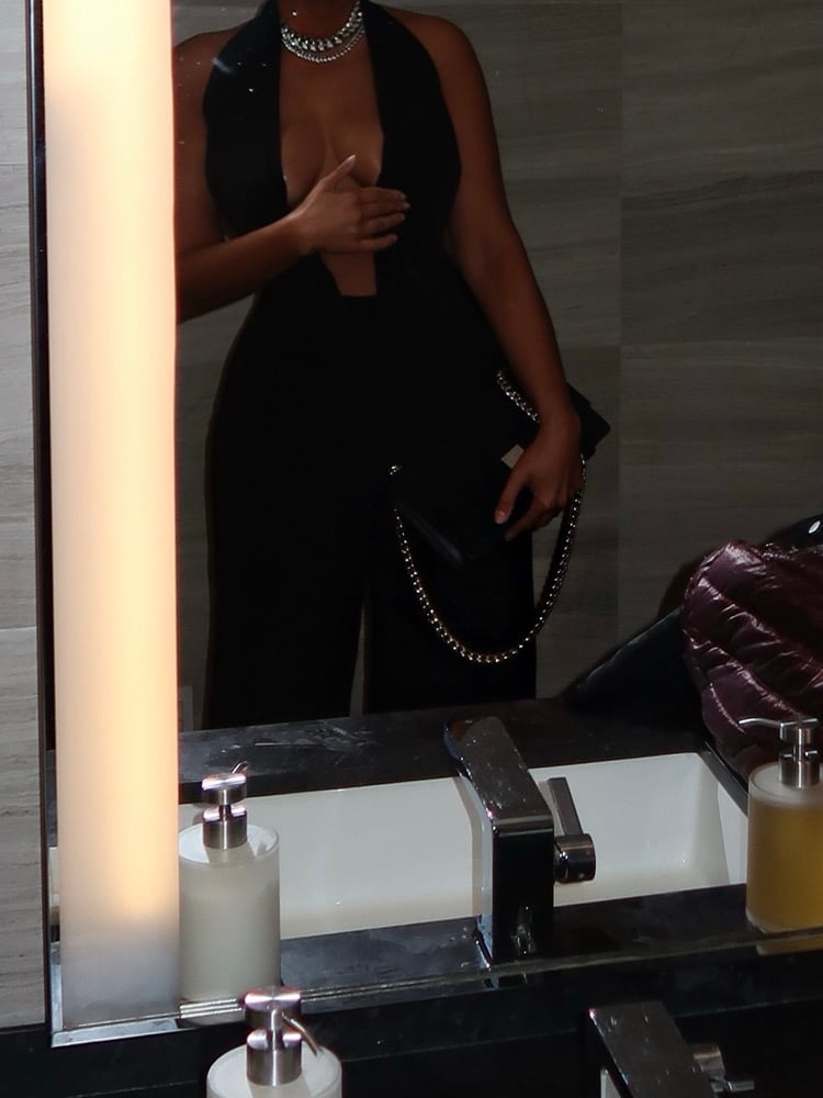 Image of BLACK LOW CUT HALTER FLARED JUMPSUIT (M)