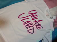 Image 3 of You are loved white with pink writing 