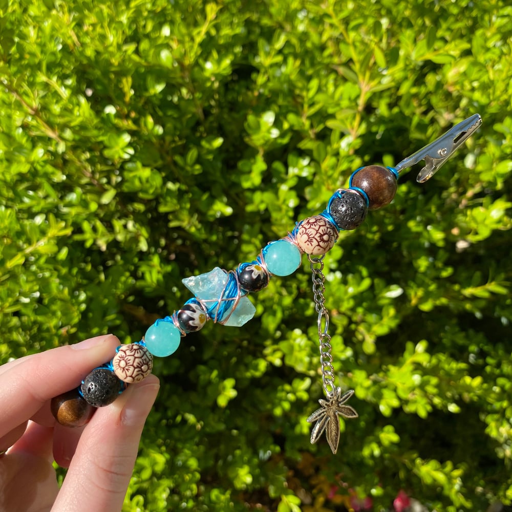 Image of aqua flower roach clip 