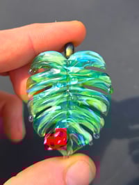 Image 2 of Drippy UV variegated monstera leaf with ladybug pendant. 🐞🌿