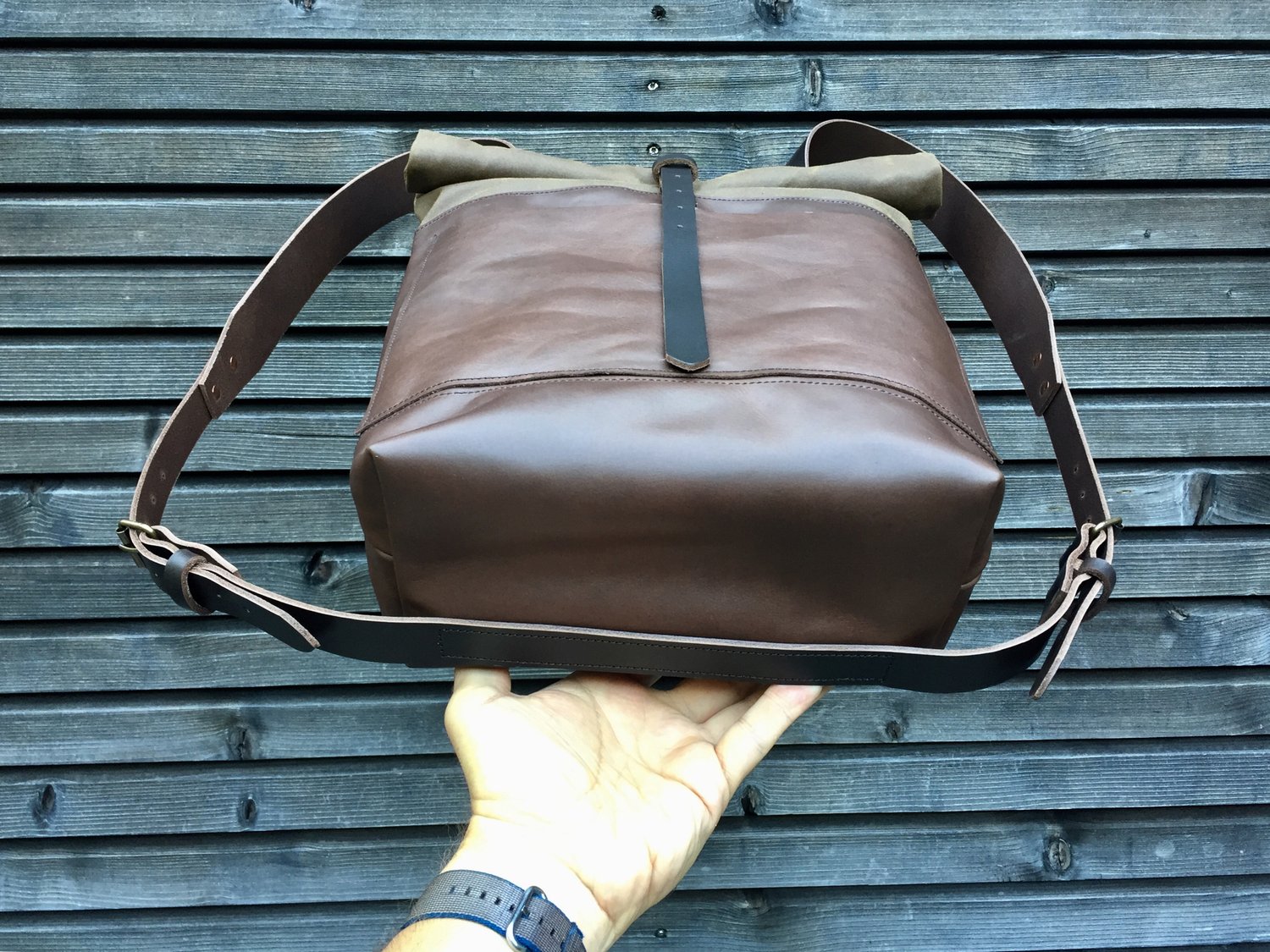 Image of Leather backpack with waxed canvas roll to close top and double outside pocket