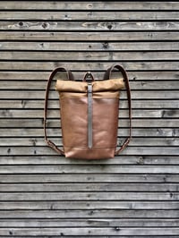 Image 1 of Leather backpack with waxed canvas roll to close top and double outside pocket