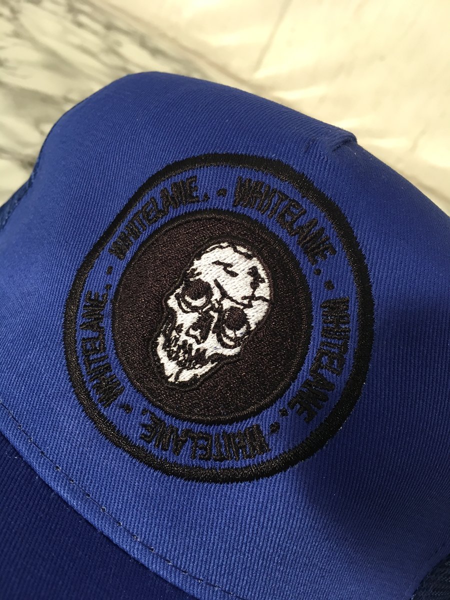 Image of Royal blue skull emblem trucker cap