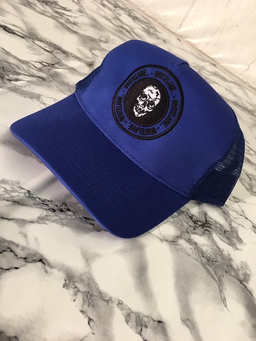 Image of Royal blue skull emblem trucker cap