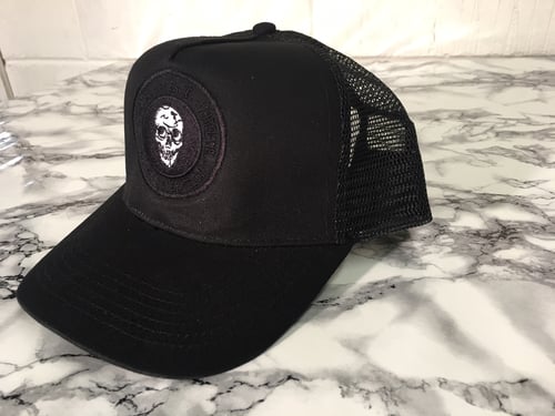 Image of Black skull emblem trucker cap