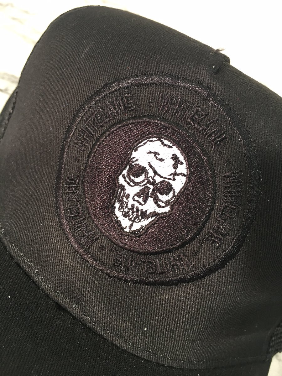 Image of Black skull emblem trucker cap