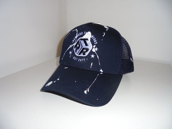 Image of Navy Blue Paint Splash Rewards Take Risks Trucker Cap