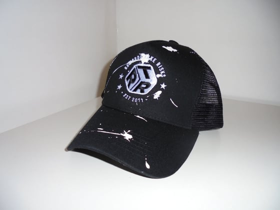 Image of Black Paint Splash Rewards Take Risks Trucker Cap