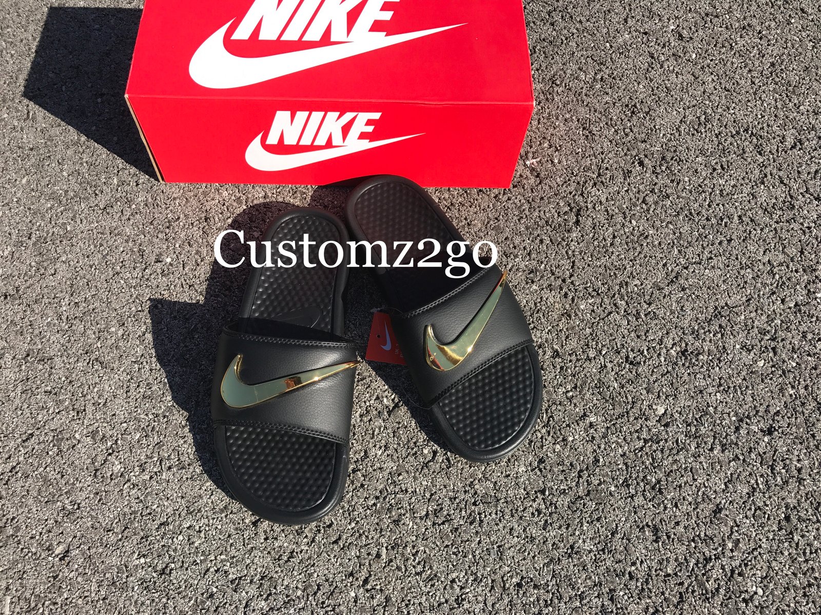 red nike sandals with gold check