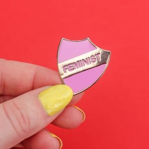 Image of FEMINIST - enamel pin, shield, pink with gold plating, merit style badge