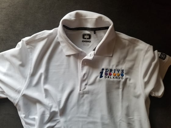 Image of OGIO White Golf Polo Shirt with IDrive Orlando Logo