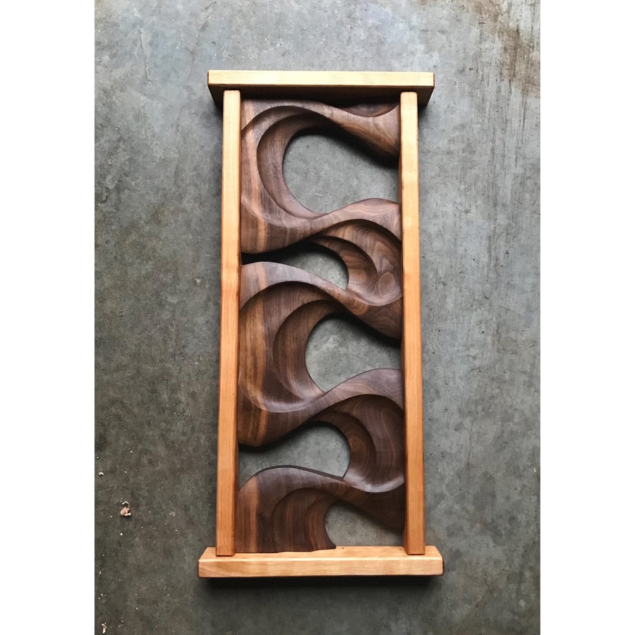 Image of Floating in slow motion. Walnut wall hanging.