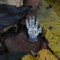 Hand of glory enamel pin.