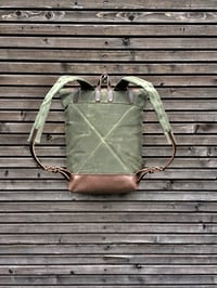 Image 4 of Waxed canvas backpack with roll to close top with leather bottom and outside pocket in dark taupe