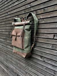 Image 5 of Waxed canvas backpack with roll to close top with leather bottom and outside pocket in dark taupe