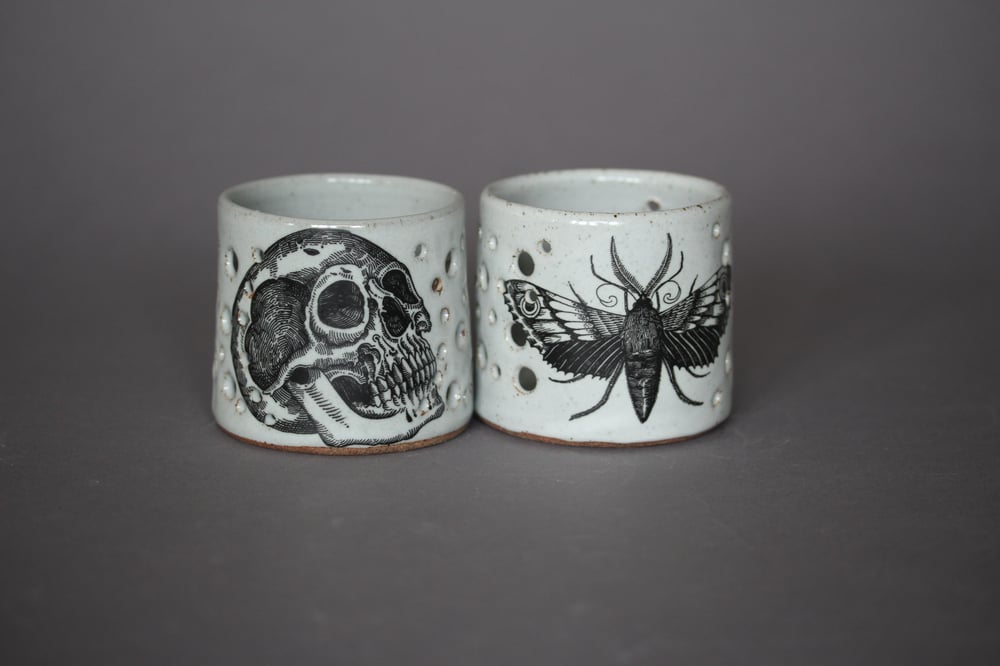 Moth and skull candle holders.