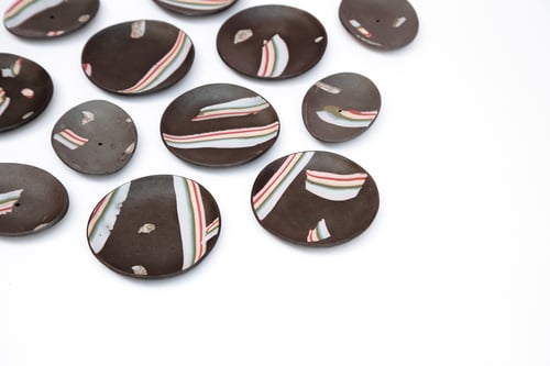 Image of Rainbow over dark sky incense holders