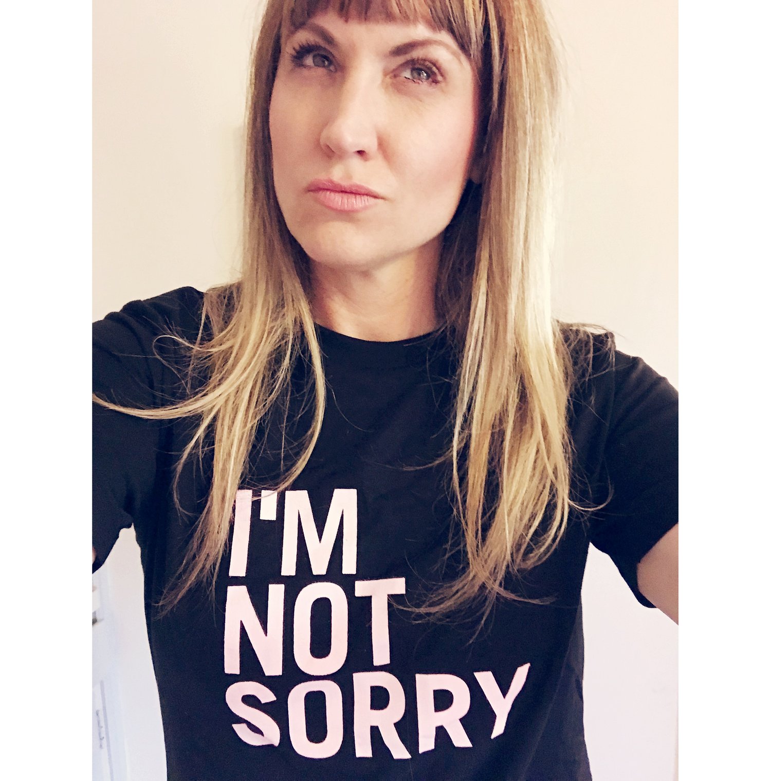 Image of I'M NOT SORRY t-shirt for adults, pink writing on black tee
