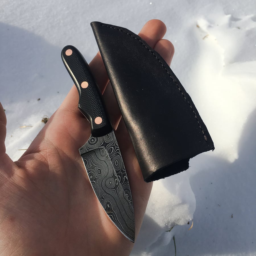 Image of Damascus Carrier w/ Black g-10 scales, copper pins and black leather sheath