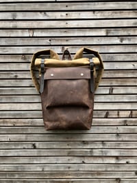 Image 1 of Leather backpack with waxed canvas roll to close top and leather front pocket