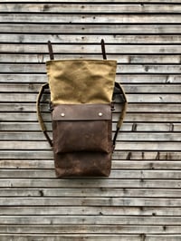 Image 3 of Leather backpack with waxed canvas roll to close top and leather front pocket