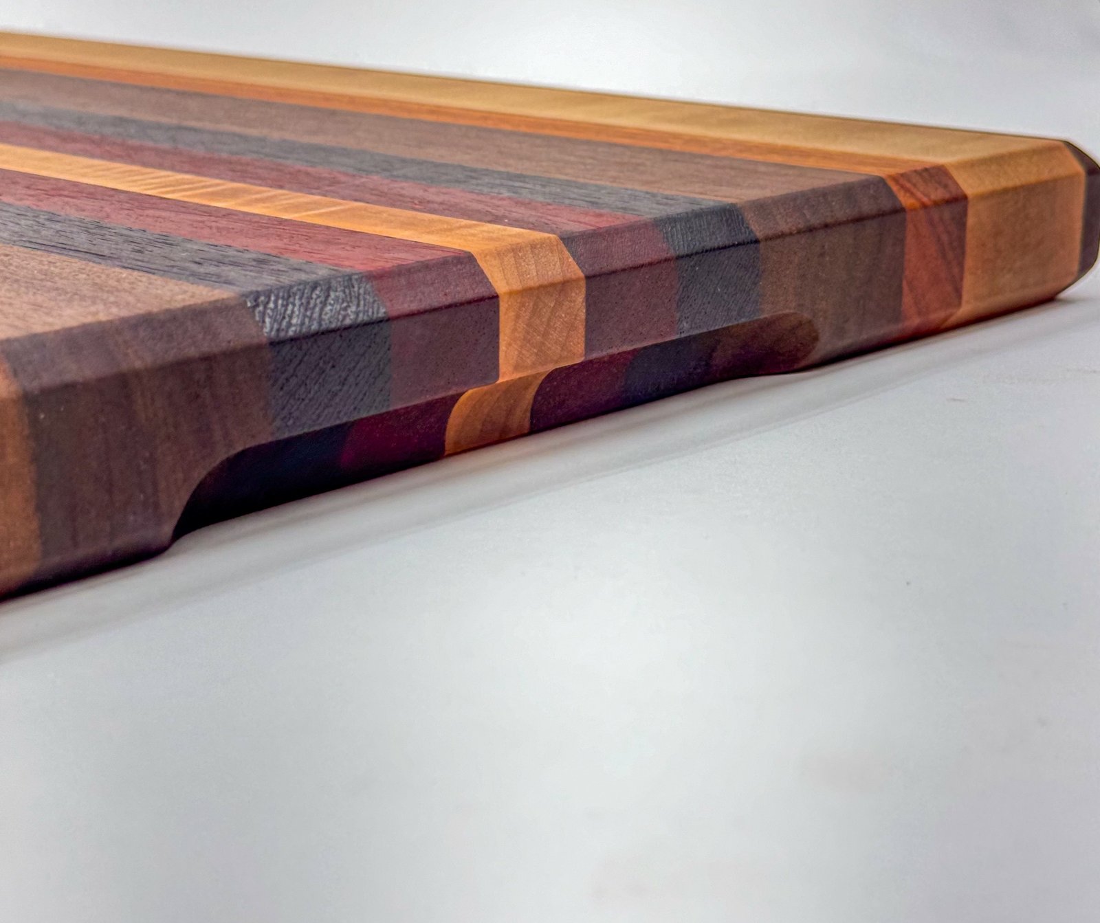 Walnut, Maple, deals Wenge and Padauk edge-grain cutting board.