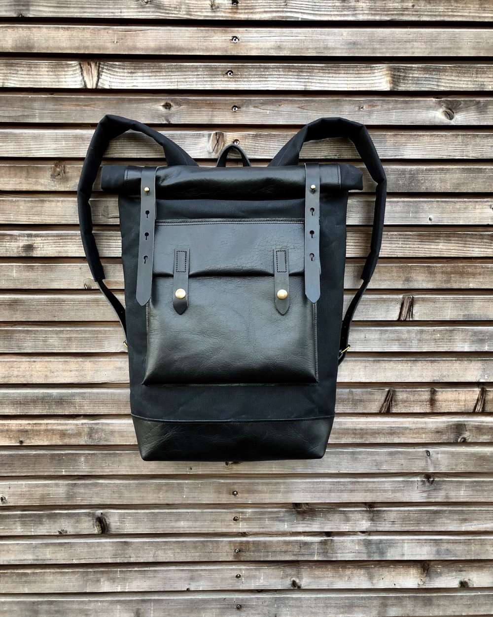 Image of Black waxed canvas rucksack/backpack with roll up top and oiled leather bottem COLLECTION UNISEX