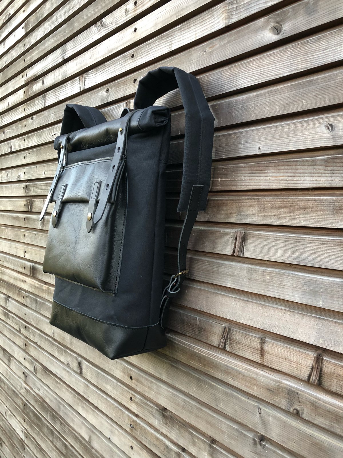 Image of Black waxed canvas rucksack/backpack with roll up top and oiled leather bottem COLLECTION UNISEX