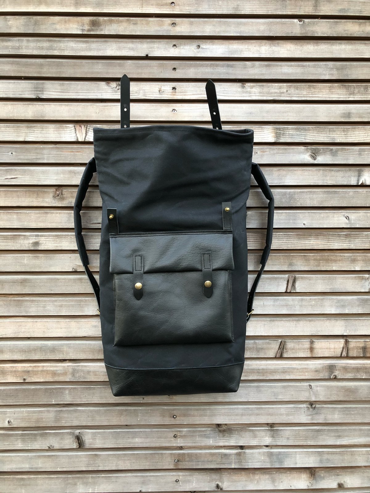 Image of Black waxed canvas rucksack/backpack with roll up top and oiled leather bottem COLLECTION UNISEX
