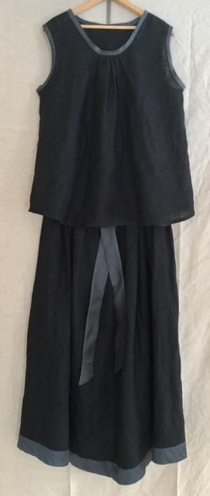 Image of long black linen pleated skirt with silk bands