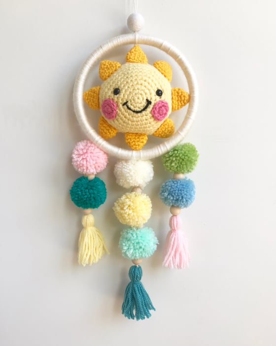 Image of Sunny pom pom hanging