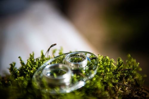 Image of silver wedding rings with inscription in Latin