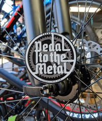 Image 1 of 'Pedal to the Metal' matte finish round vinyl sticker.