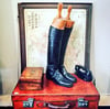Pair of leather riding boots and antique wooden boot lasts. 