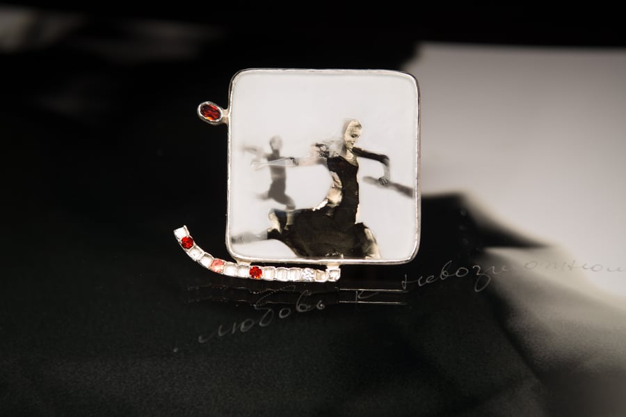 Image of sterling silver brooch with garnets, topaz and ballet photography under glass