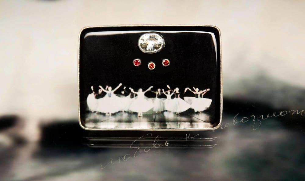 Image of sterling silver brooch with topaz, sapphires and ballet photography under plexiglass