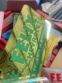 Image 1 of GOLD & LIGHT BLUE FELIX CHEVROLET ICONIC LICENSE PLATE