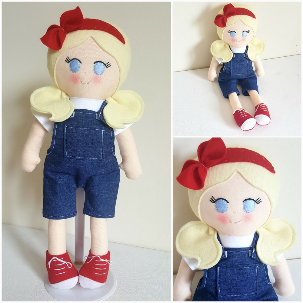 Image of Large blonde doll in denim dungarees