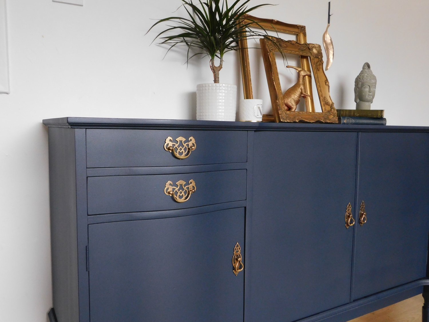 Image of A dark blue wooden sideboard